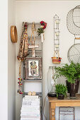 Ladder with ethnic accessories next to a console table with fern