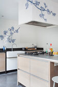 White wall tiles with floral motif in kitchen