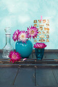 Dahlias in blue vase and blue glass