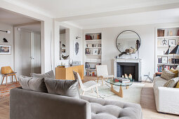 Open-plan designer living room in pale earthy tones