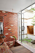 Shower with brick wall and garden access