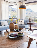 Pale blue sofa and panoramic windows in classic living room