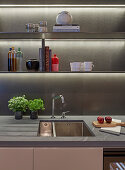Open kitchen shelves with indirect lighting above sink