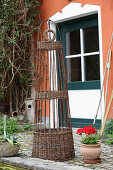Decorative wicker obelisk outside house