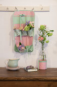 Posies and thread reels in organiser made from mint-green and pink fabric