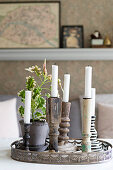 Various old candlesticks on delicate metal tray