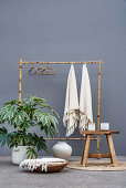 Aralia and bamboo coat rack in front of grey wall