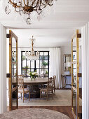Glance into the dining room with a round table and antique, Gustavian chairs