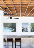 Breakfast counter with bar stools, large-format photo art on the wall