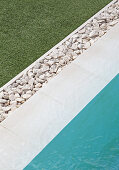 Straight lines formed by lawn, pebbles, pool surround and water