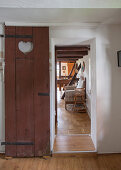 DIY sliding door made from old privy door with heart-shaped cutout