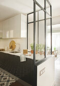 Partition wall half made from glass screening kitchen