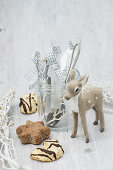 Cutlery and handmade name tags in jar, Christmas biscuits and deer figurine