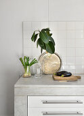 Simple decorative arrangement on marble kitchen worksurface