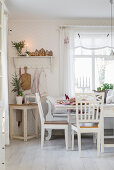 Table and chairs in festively decorated kitchen-dining room