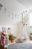 Wigwam in child's bedroom with sloping ceiling