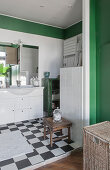Open-plan bathroom with chequered floor and green accents