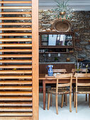 View into rustic dining room with stone wall