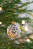 Christmas-tree bauble decorated with newspaper and bead heart