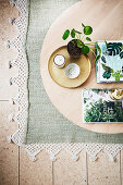 Pilea and books on a round wooden coffee table