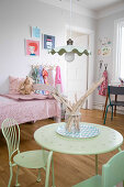 Lime-green table and chairs in vintage-style child's bedroom