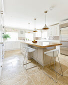 Large, bright country-house kitchen with stone-flagged floor