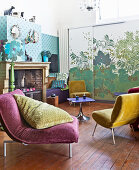 Velvet easy chairs in front of old fireplace and sliding element with plant motif
