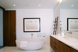 Free-standing bathtub and washstand with marble top in elegant bathroom