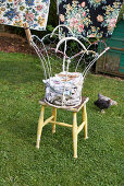 Wire basket of laundry on stool in garden