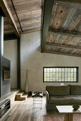 Rustic living area in earthy shades with exposed roof structure and clerestory windows