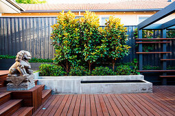 Modern back yard garden with terrace, beds and pergola