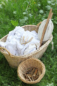 Basket of laundry hand-washed and bleached using traditional methods with washing line and basket of pegs