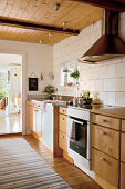 Country-house kitchen with wooden cabinets