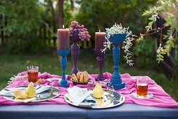 Table festively set in blue and purple in garden