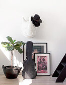 Rhinoceros hats on paper mache, posters, guitar and houseplant