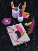 Homemade paper feathers as a gift and desk decoration