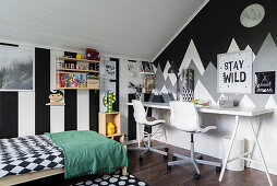 Wide stripes and mountains painted on walls of monochrome child's bedroom