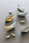 Small paper boats made from folded maps