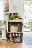 Old wooden crates used as kitchen counter with potted herbs on top
