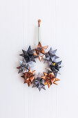 Christmas wreath of origami stars in grey and copper