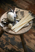 Candles, vintage ornaments and old photos on wooden stool