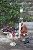 Mini bundt cakes, cherries and liqueur on garden table