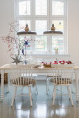 Festive decorations in dining room in pale grey and white