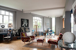 Kilim chairs in open-plan studio with grey walls