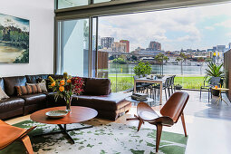 Living room with glass front to the terrace and city panorama