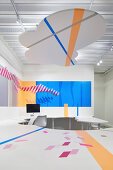 Graphic design on desk and wall in office with cloud-shaped suspended ceiling at HARU Gallery, London, United Kingdom