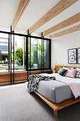 Double bed in elegant bedroom with window front