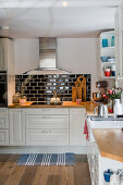 Black subway tiles in country-house kitchen