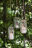 DIY candle lanterns hung from tree