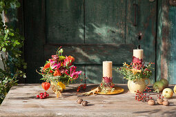 Autumnal arrangement of candles and flowers